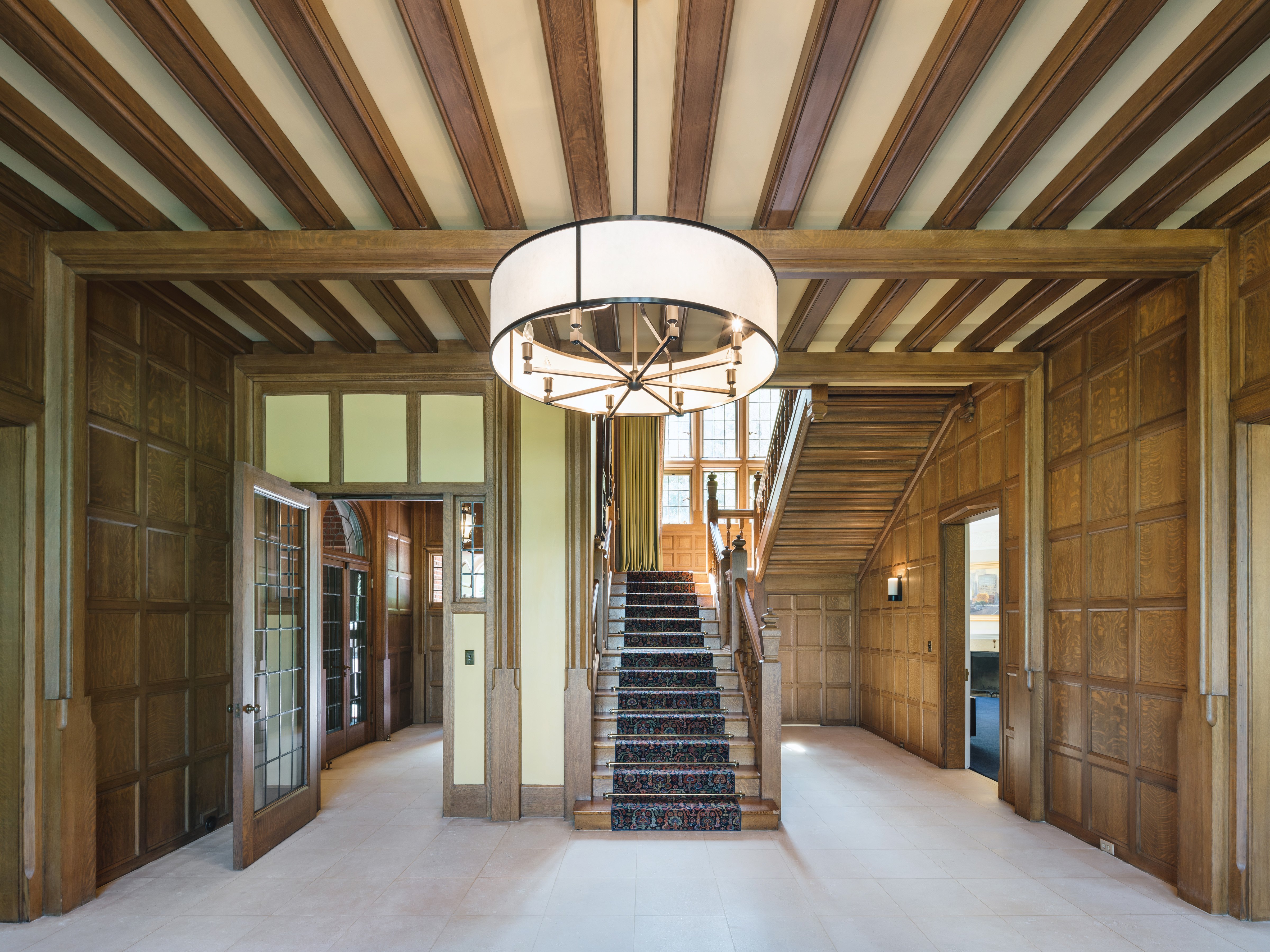 Opening featuring limestone flooring and a wood panneling and railway