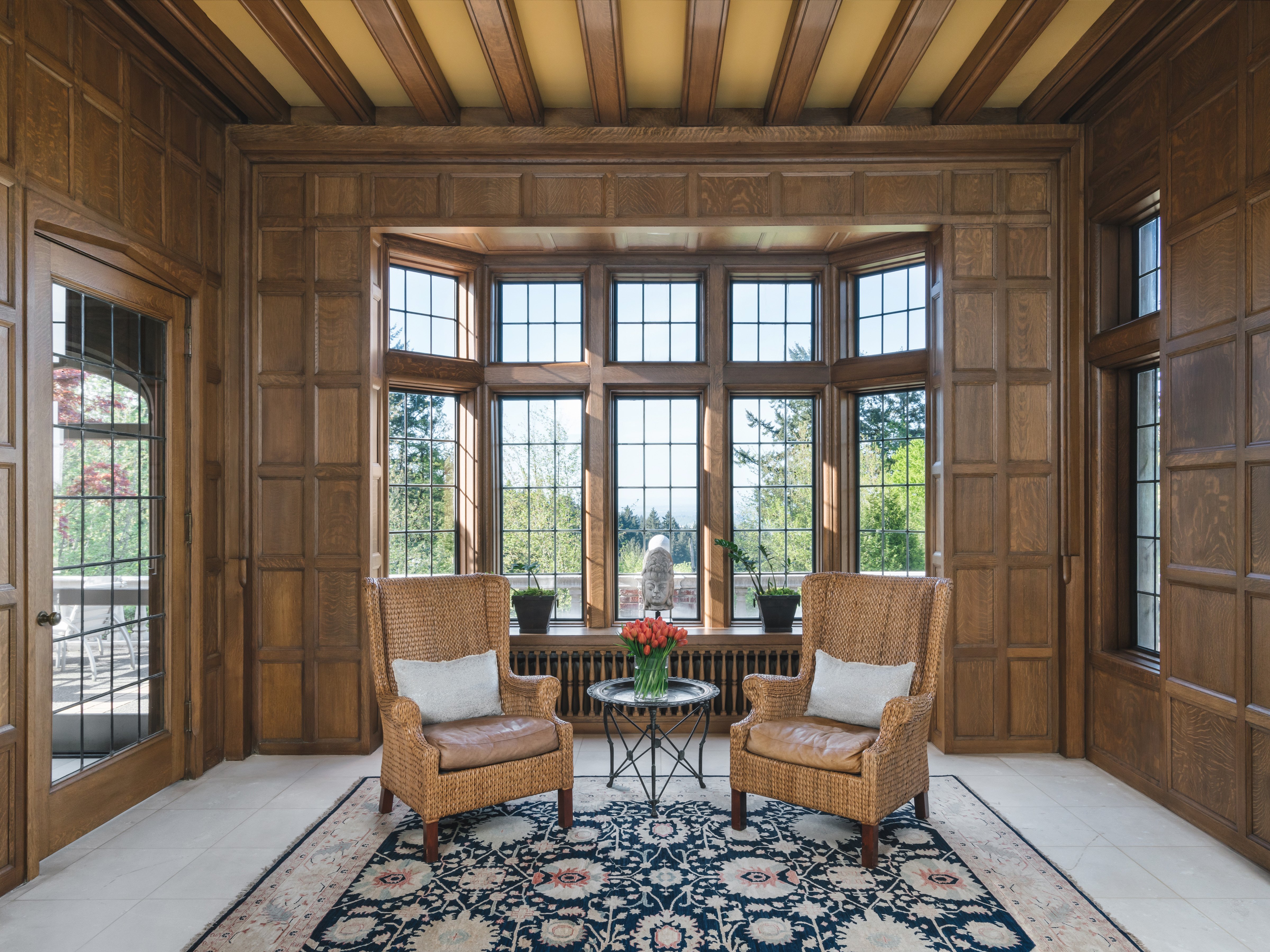 Sitting area featuring wood panneling and limestone flooring
