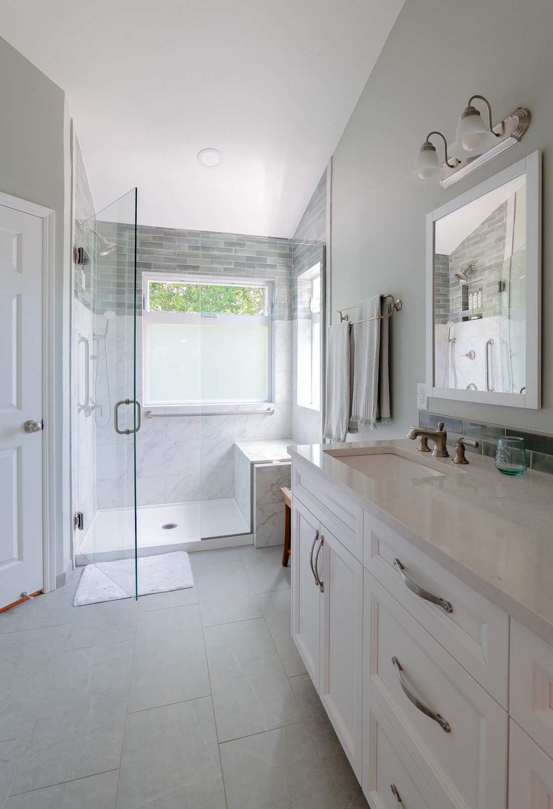 Vanity and grey tile shower