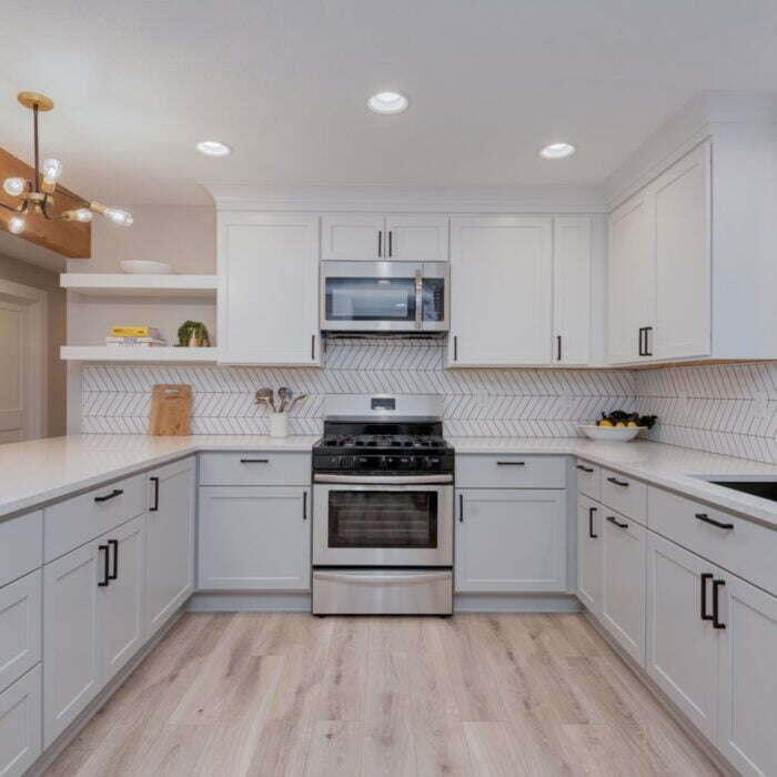 Kitchen in a basement ADU featuring white cabinets and quartz countertops