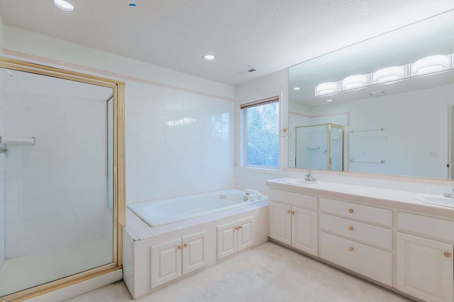 bathroom before a remodel with outdated tub insert and fiberglass shower