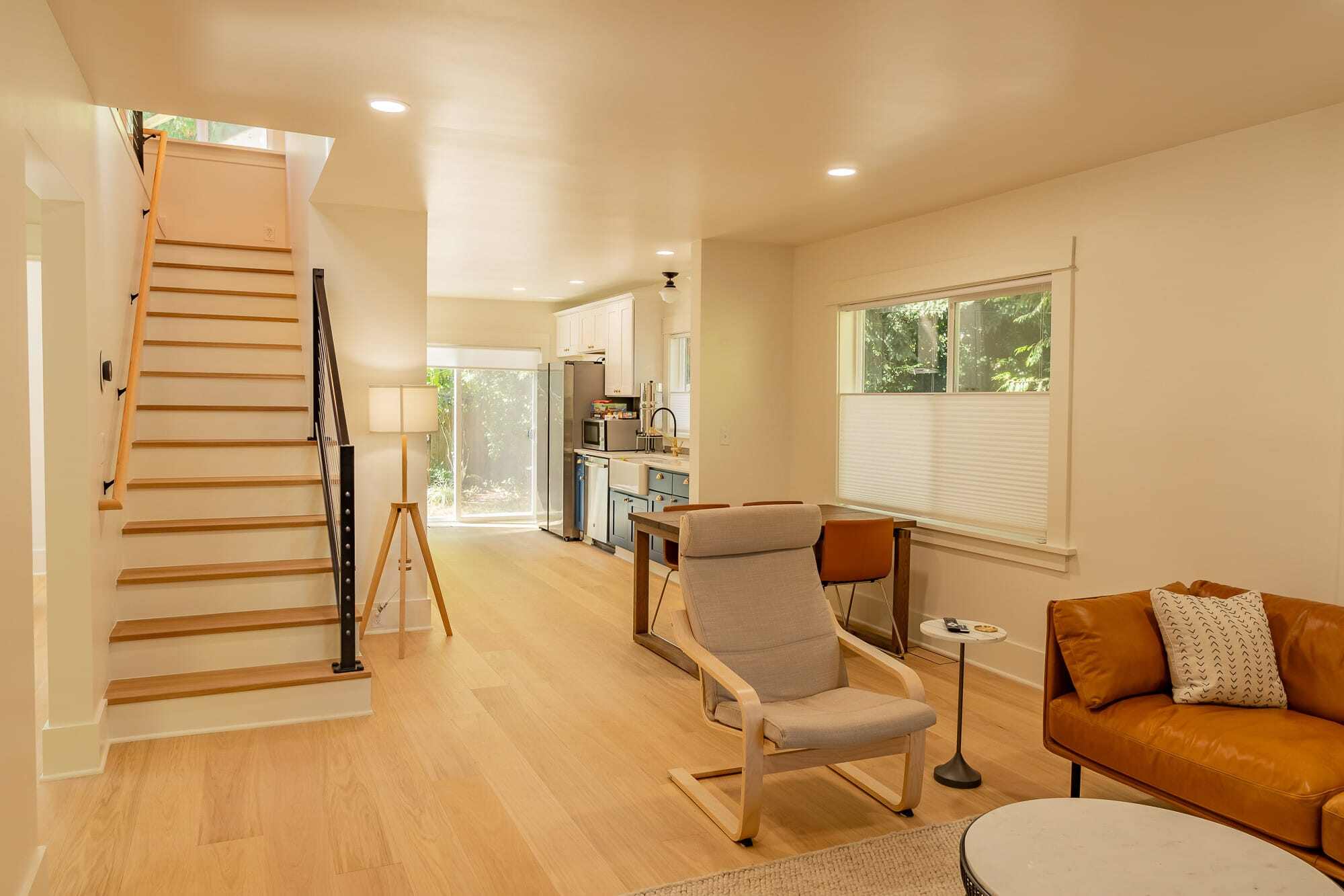 home remodel of a historic home in Portland's Concordia neighborhood after construction with open floor plan and light wood floors