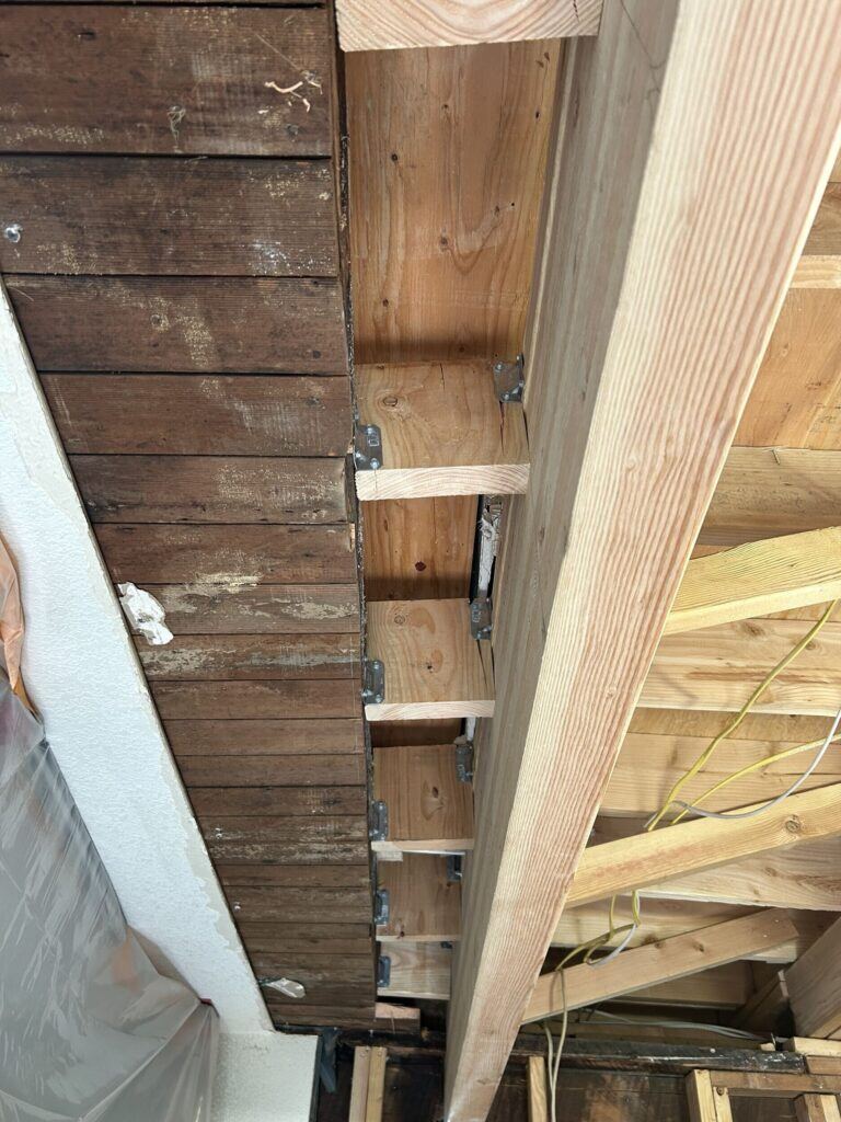 support blocking between a glulam and a sagging joist
