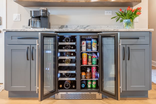 Beverage station in a kitchen filled with wine and other drinks
