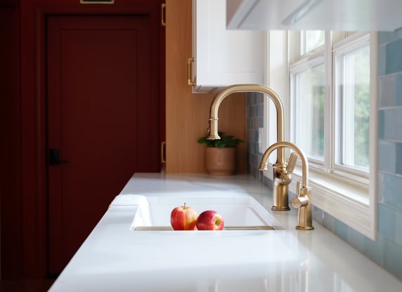 Kitchen sink with bronze fixtures with apples