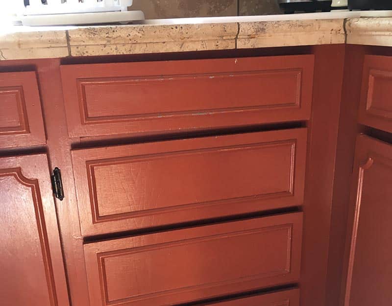when to remodel your kitchen: old damaged red cabinets